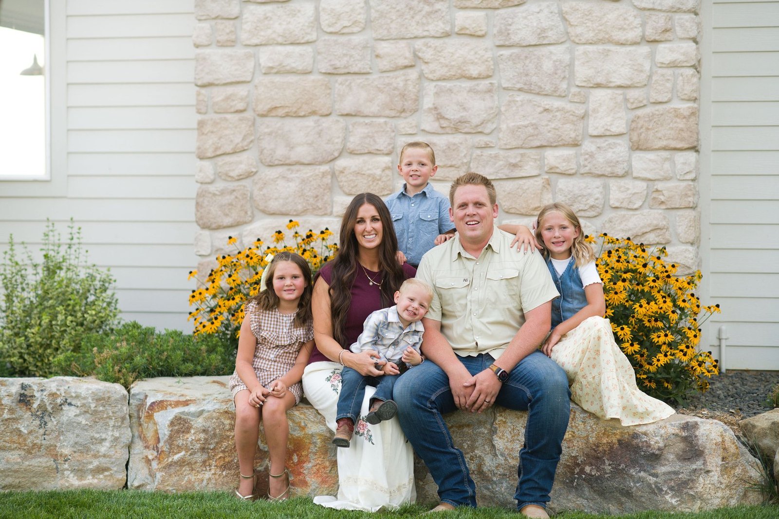 Parker Albertson with his wife and children outside a home they built