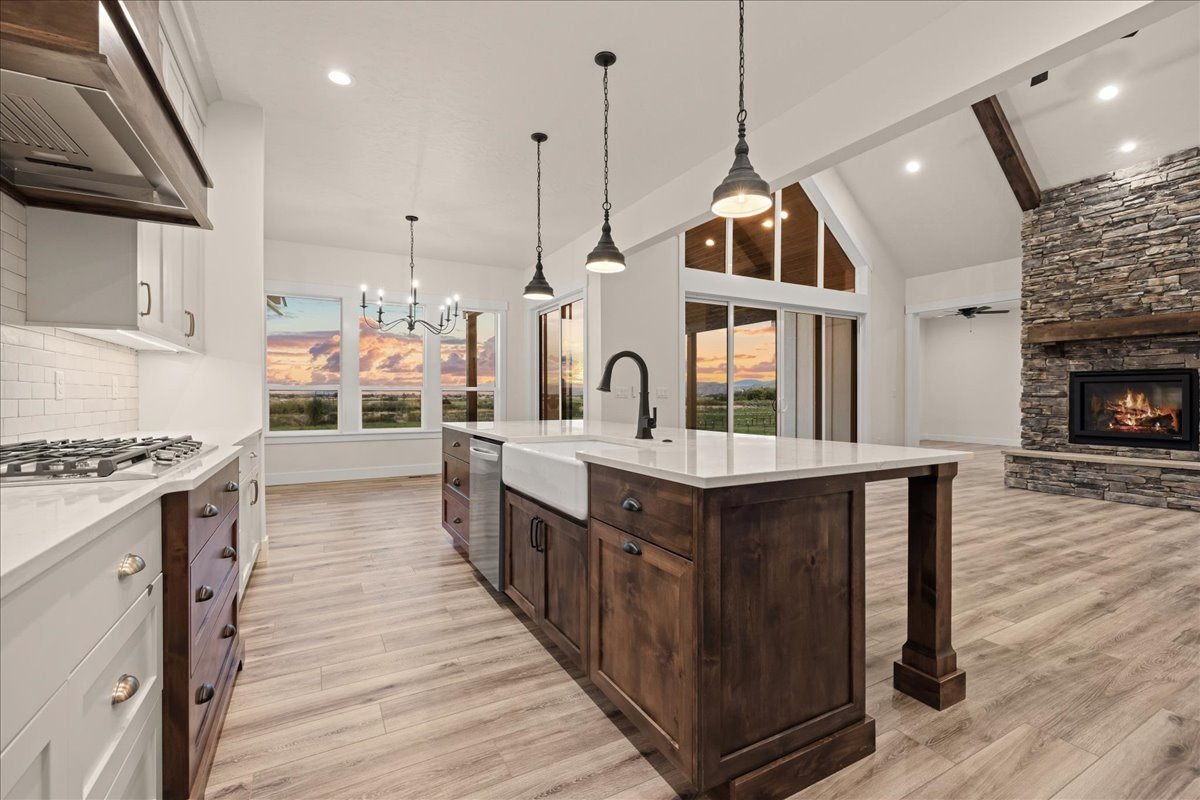 Custom kitchen with a farmhouse sink, dark wood island and vaulted ceiling