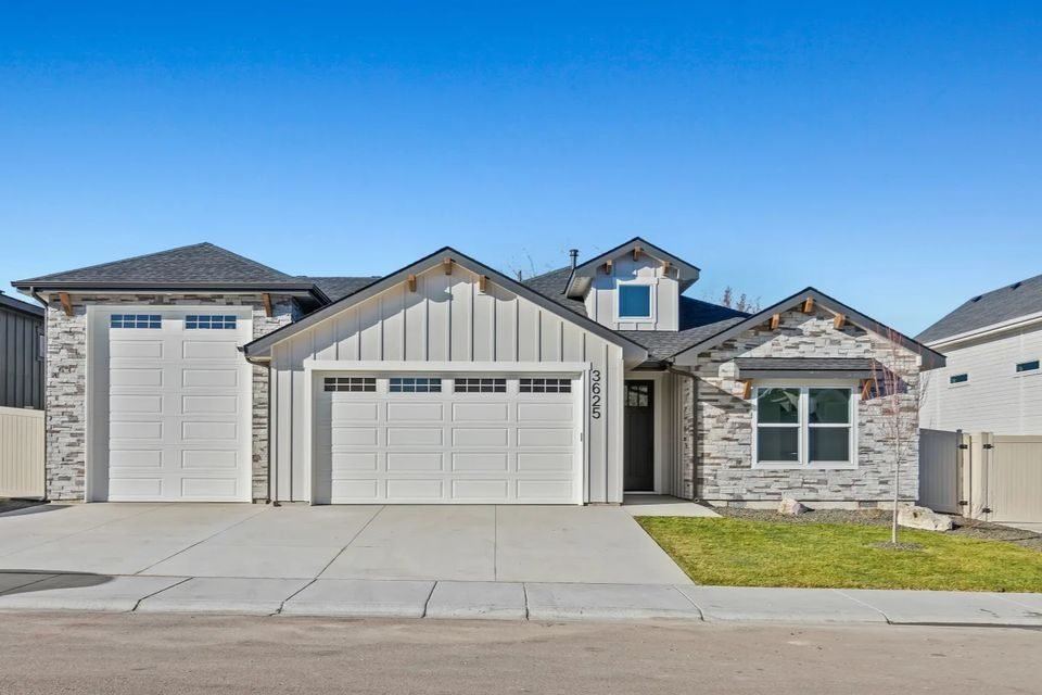Two-story custom home with a three-car garage and stone accents