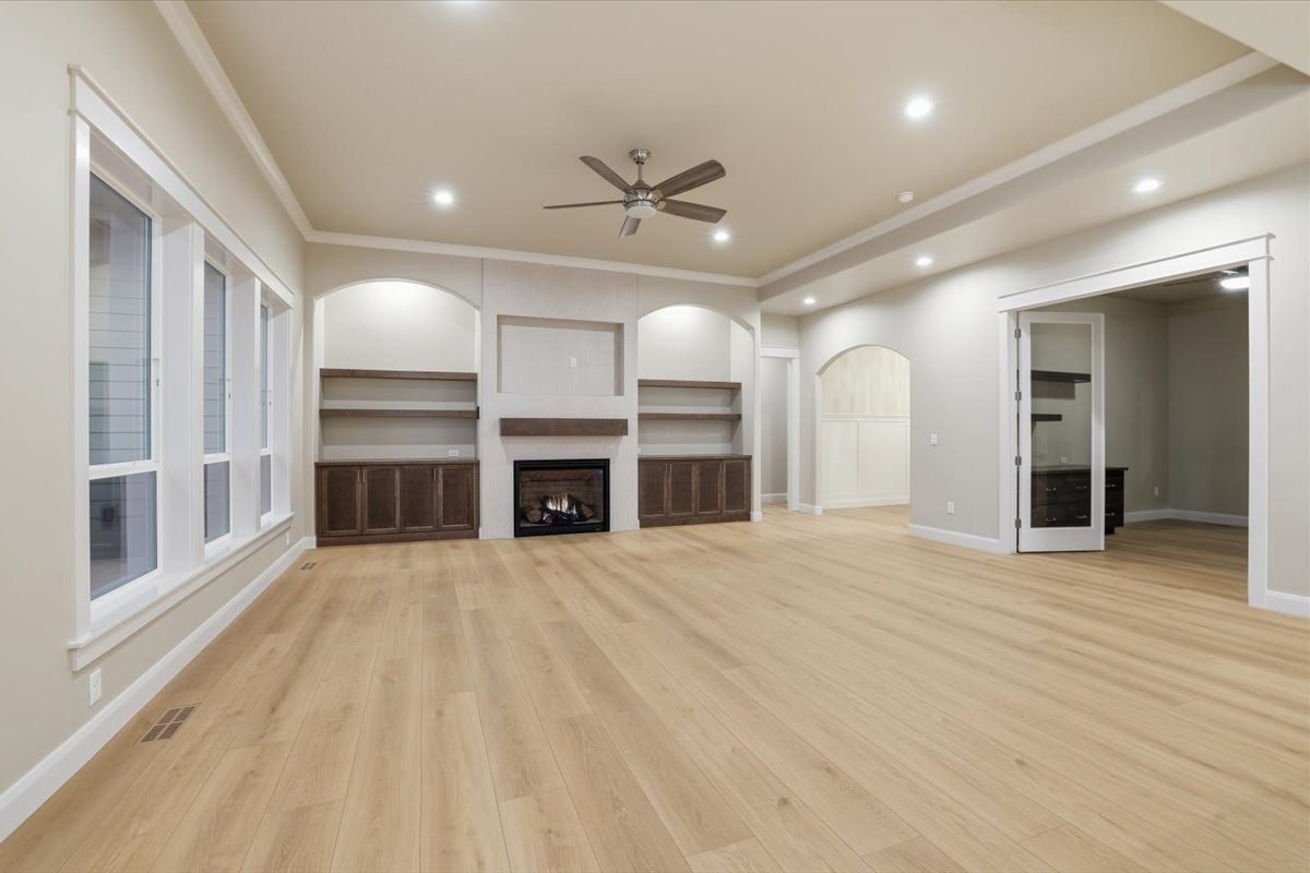 Finished great room with built-ins, a fireplace and a wall of windows, ready for move-in