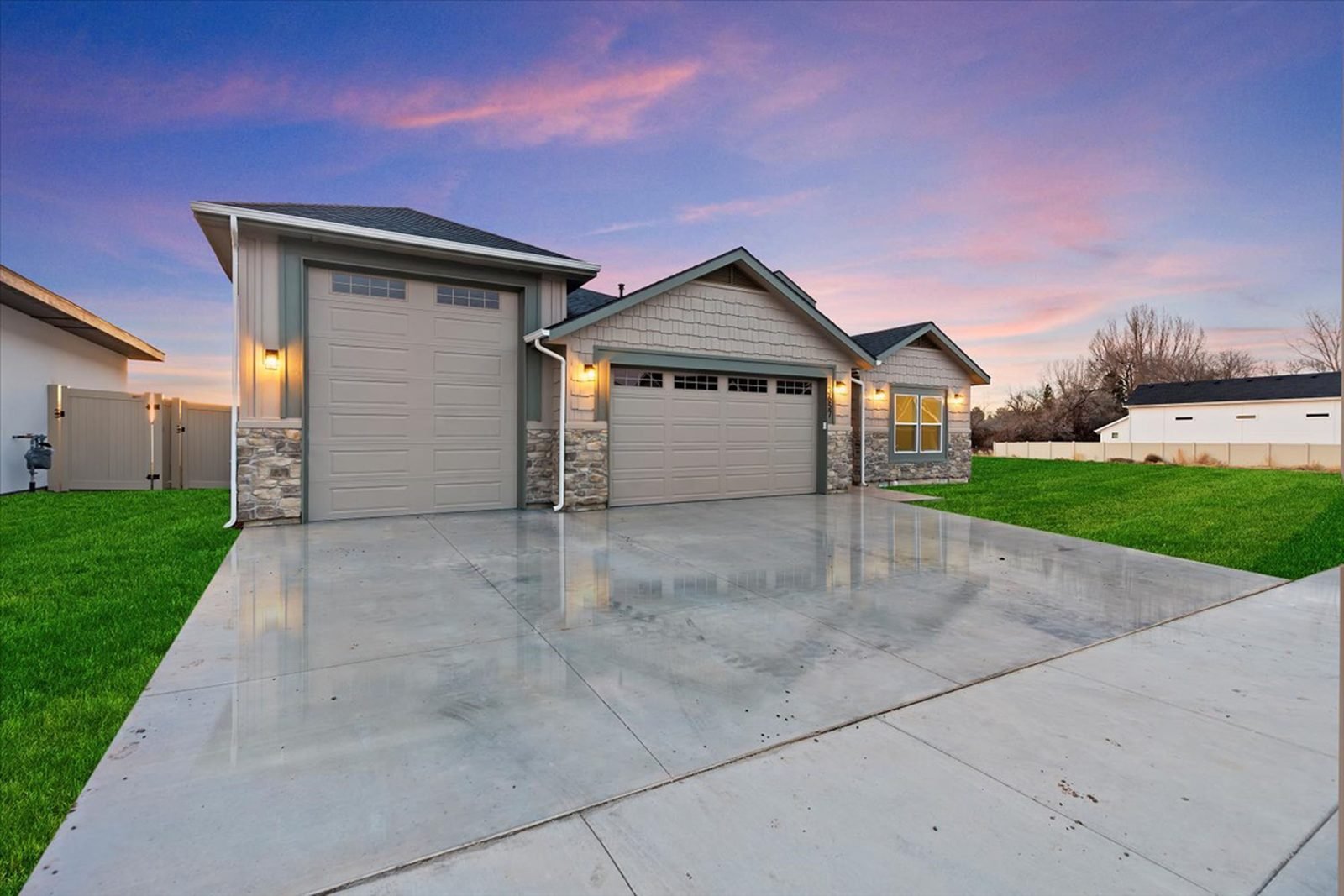 Custom home at dusk with a two-car garage